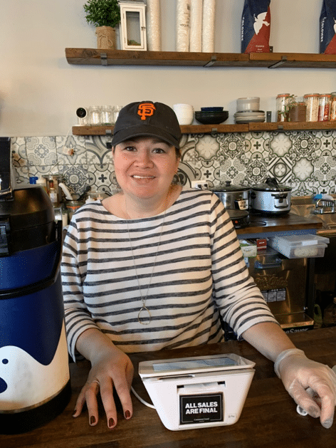 Karina Oshiro behind the counter of her coffee shop.