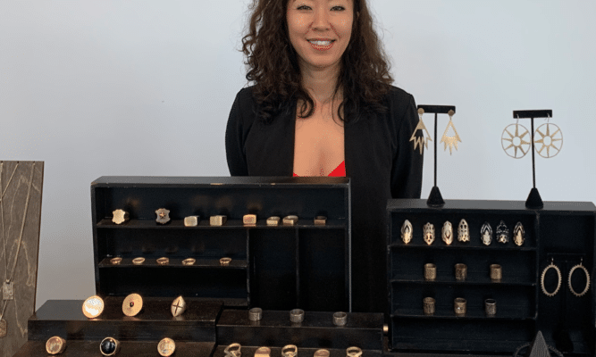 Maiko Suzuki shows her jewelry. Photo by Susan Thorson