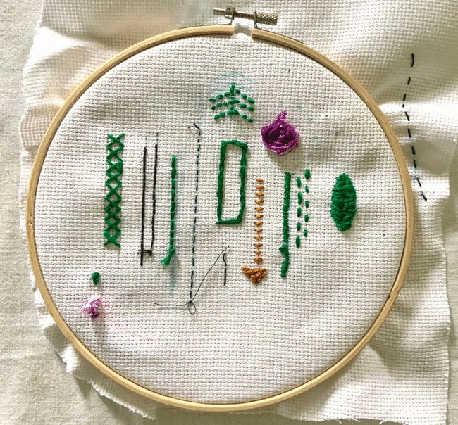 A photo of Gabriel's practice stitches on an embroidery hoop.