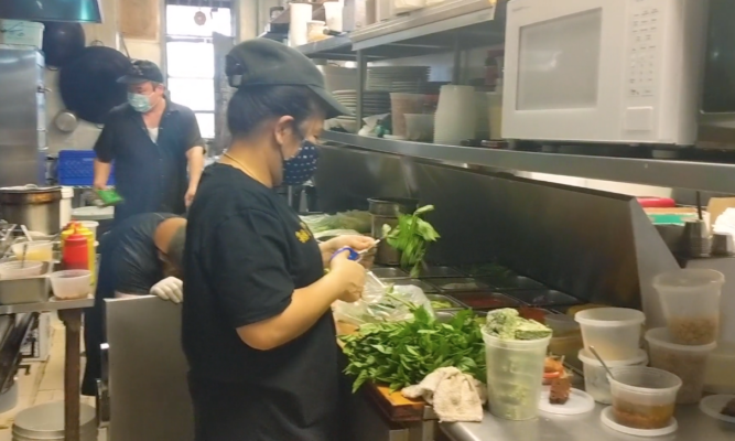 Cooking in the kitchen of Queens, New York Thai restaurant