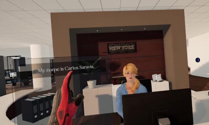 a virtual reality woman sits behind a desk. You see the gloved finger of the first-person user pointing to the discussion choice, "My name is Carlos Saravia."