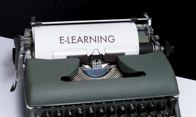 typewriter with paper and the word E-LEARNING typed on the paper