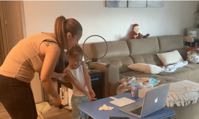 Mom helps her daughter with online Pre-K.