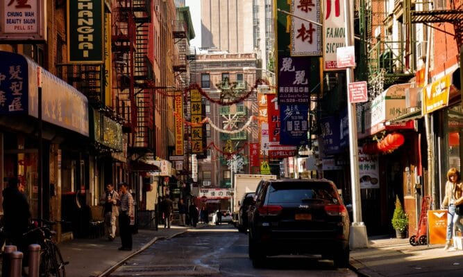 A street in Chinatown, NYC with only a handful of people present.