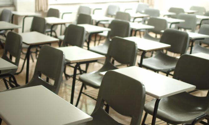 empty desks and chairs in a classroom