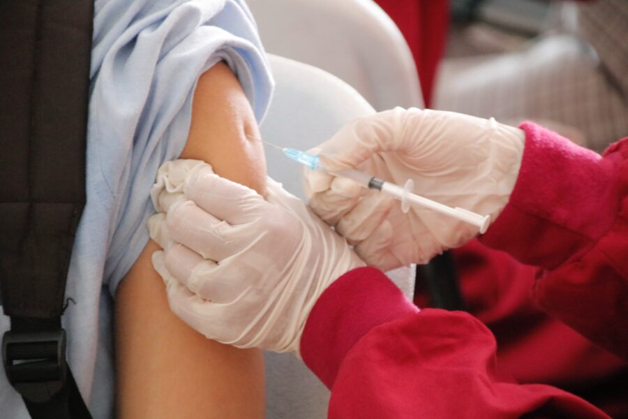 Photo of a student is being injected with a vaccine