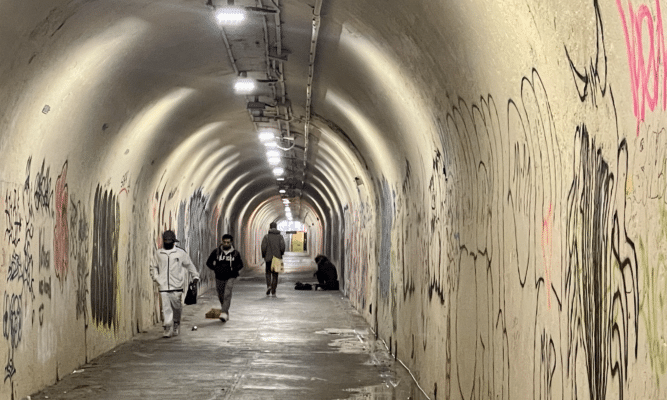 People walking through tunnel