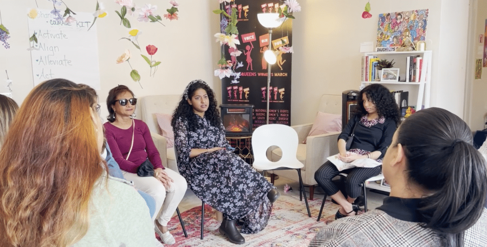 Women talking in a group at the South Queens Women's March office