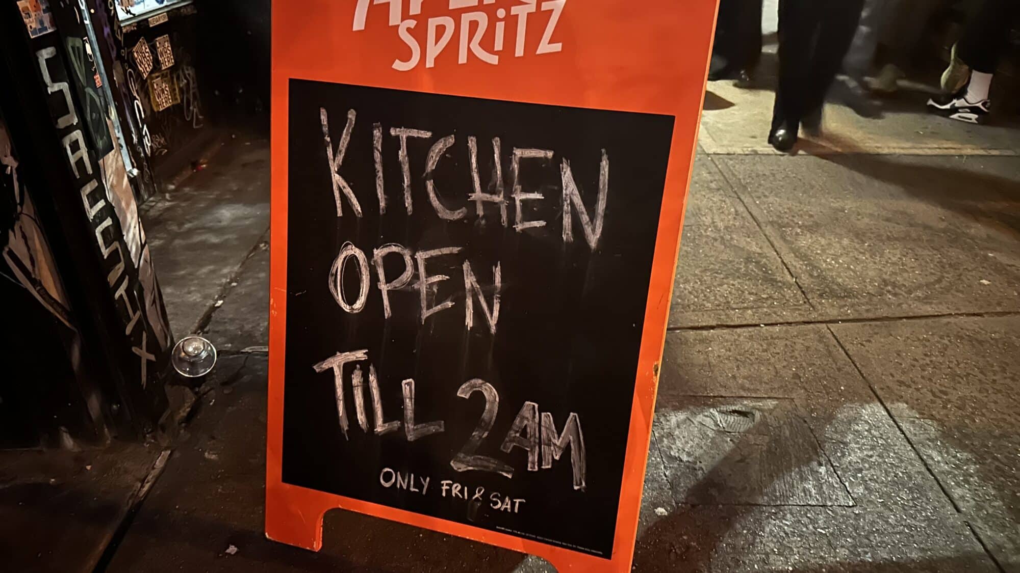 Bar sign that reads "KITCHEN OPEN TIL 2AM"
