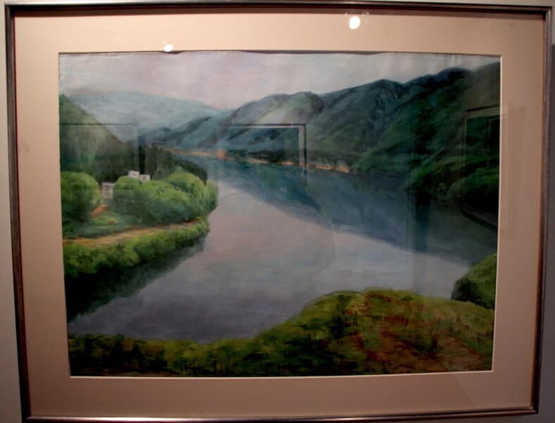 A landscape painting of green mountains overlooking a river