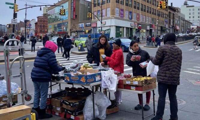 Fruit stand with customers in the South Bronx