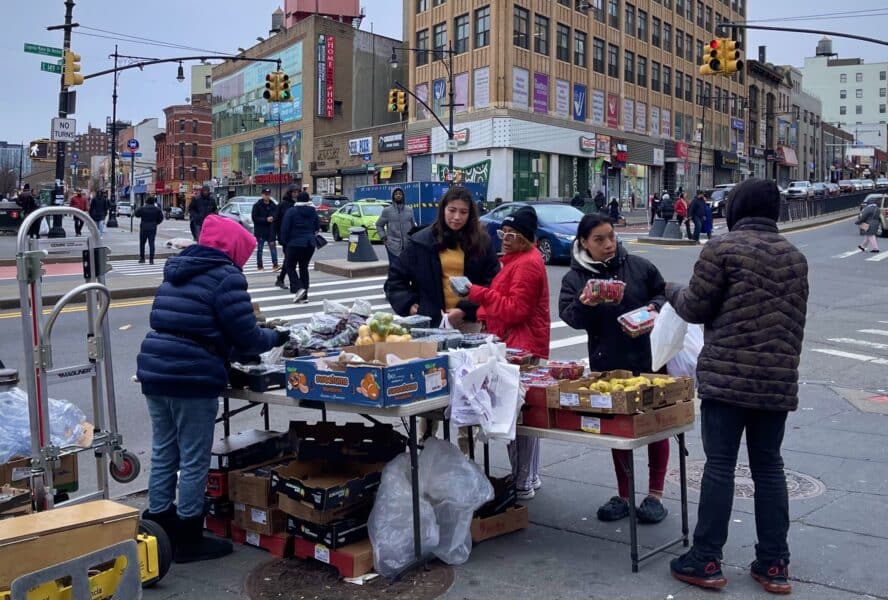 Fruit stand with customers in the South Bronx
