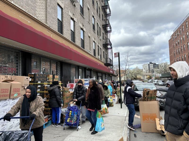 South Bronx residents receiving food from PATHHSEO volunteers.