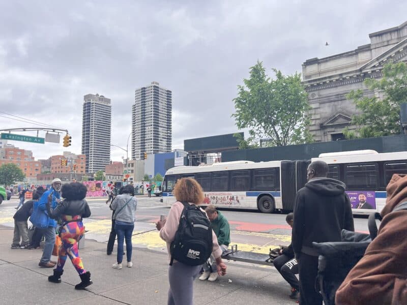 People at the bus stop at Lexington and 125 Street