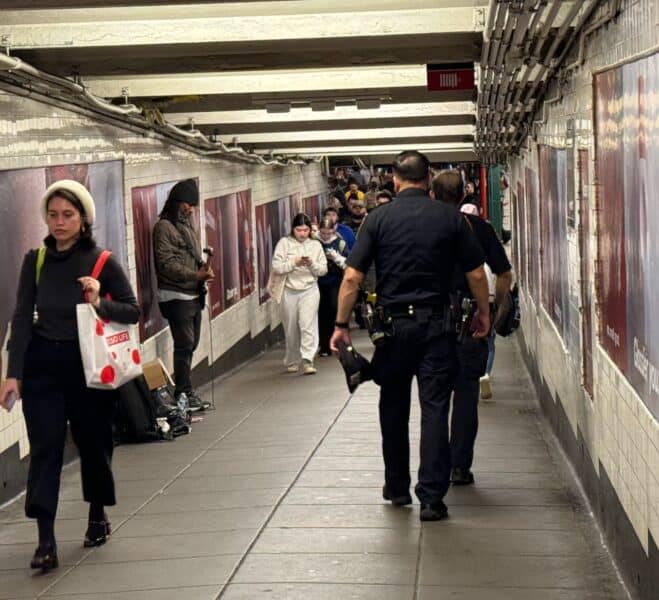 Police Officers walking toward the platform in the subway