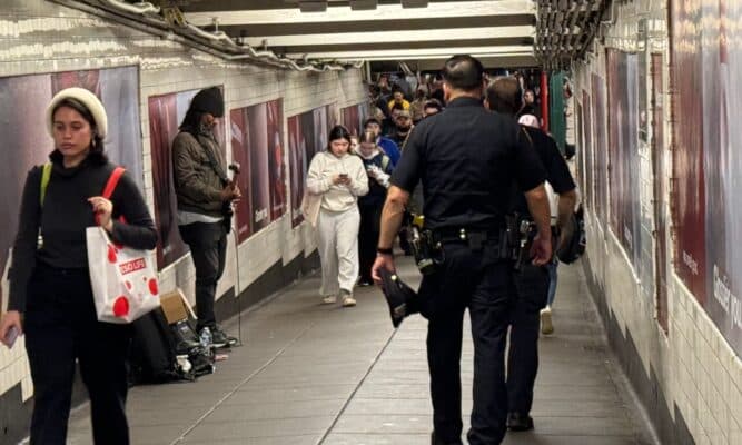 Police Officers walking toward the platform in the subway