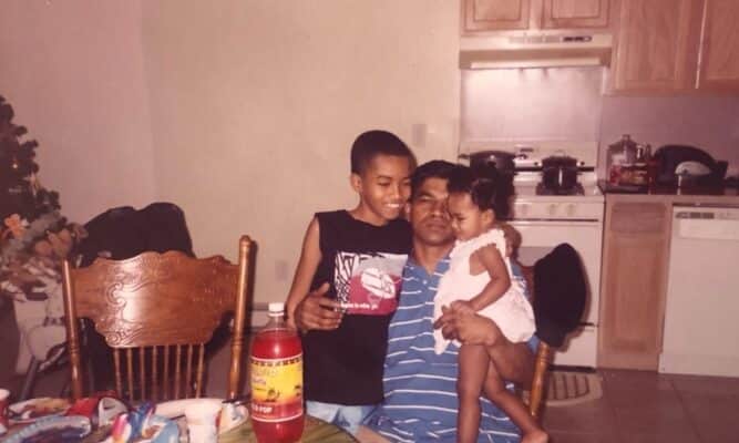 A dad and two chidlren in a kitchen