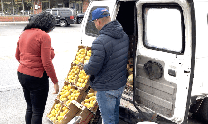 Man selling fruit from a van