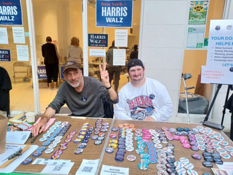 Harris volunteers outside a storefront.