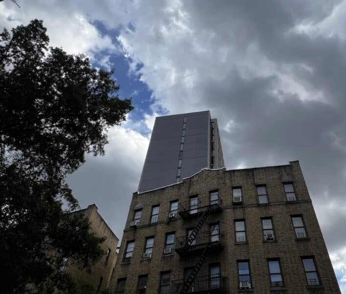 Tall building rising above a Washington Heights apartment building