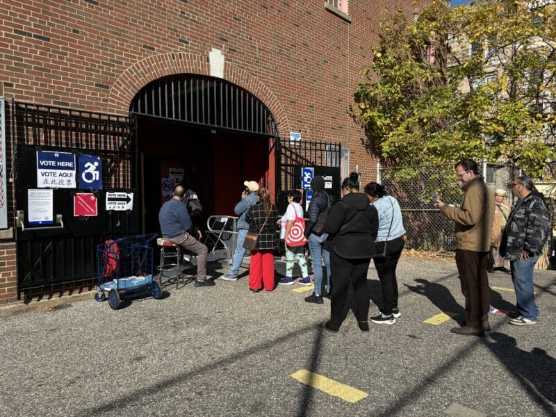 People lined up outside the Jacob Schiff Elementary School. Photo by Dayna Michels