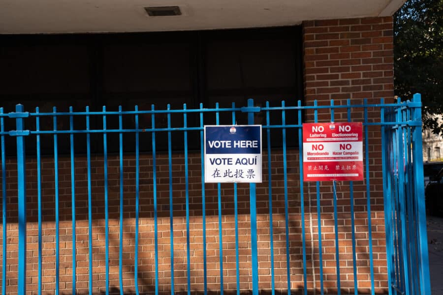 Voting signs on a school fence.