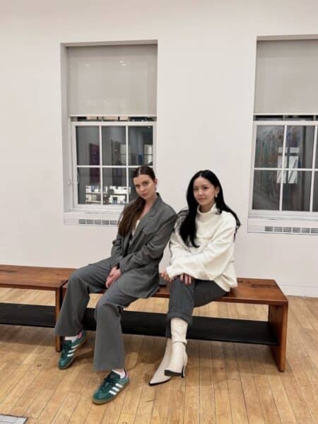 Victoria Kulikova and Damin Lee sitting on bench