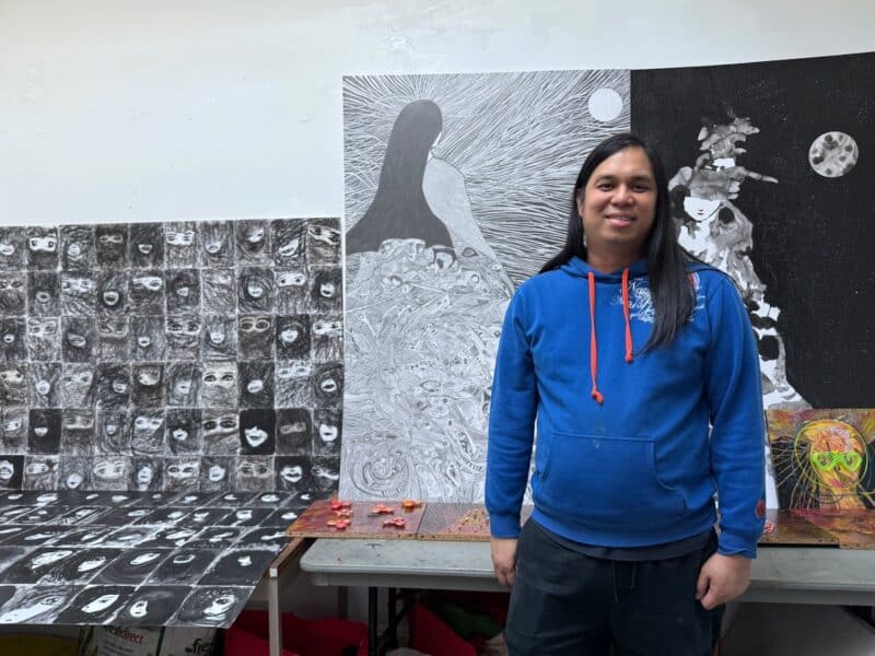 Artist Lee Jacob Hilaado in front of his work.