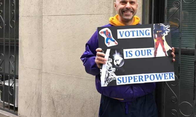 Man with a sign voting is our super power