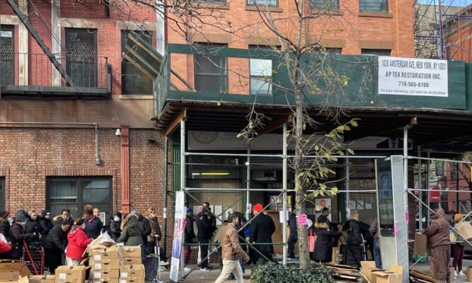 People Line Up at a Food Pantry
