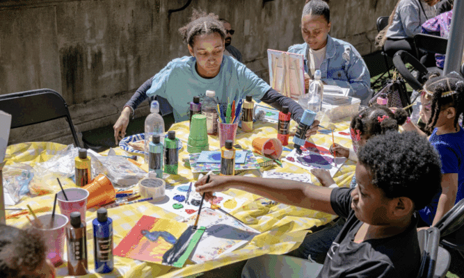 Teenagers painting in an after school program