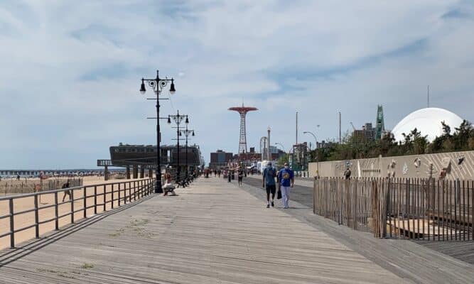 The Coney Island boardwalk, men in distance.