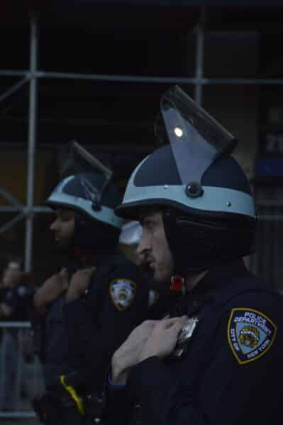 Two NYPD officers in helmets standing guard