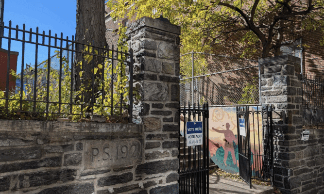 School with Vote Here sign