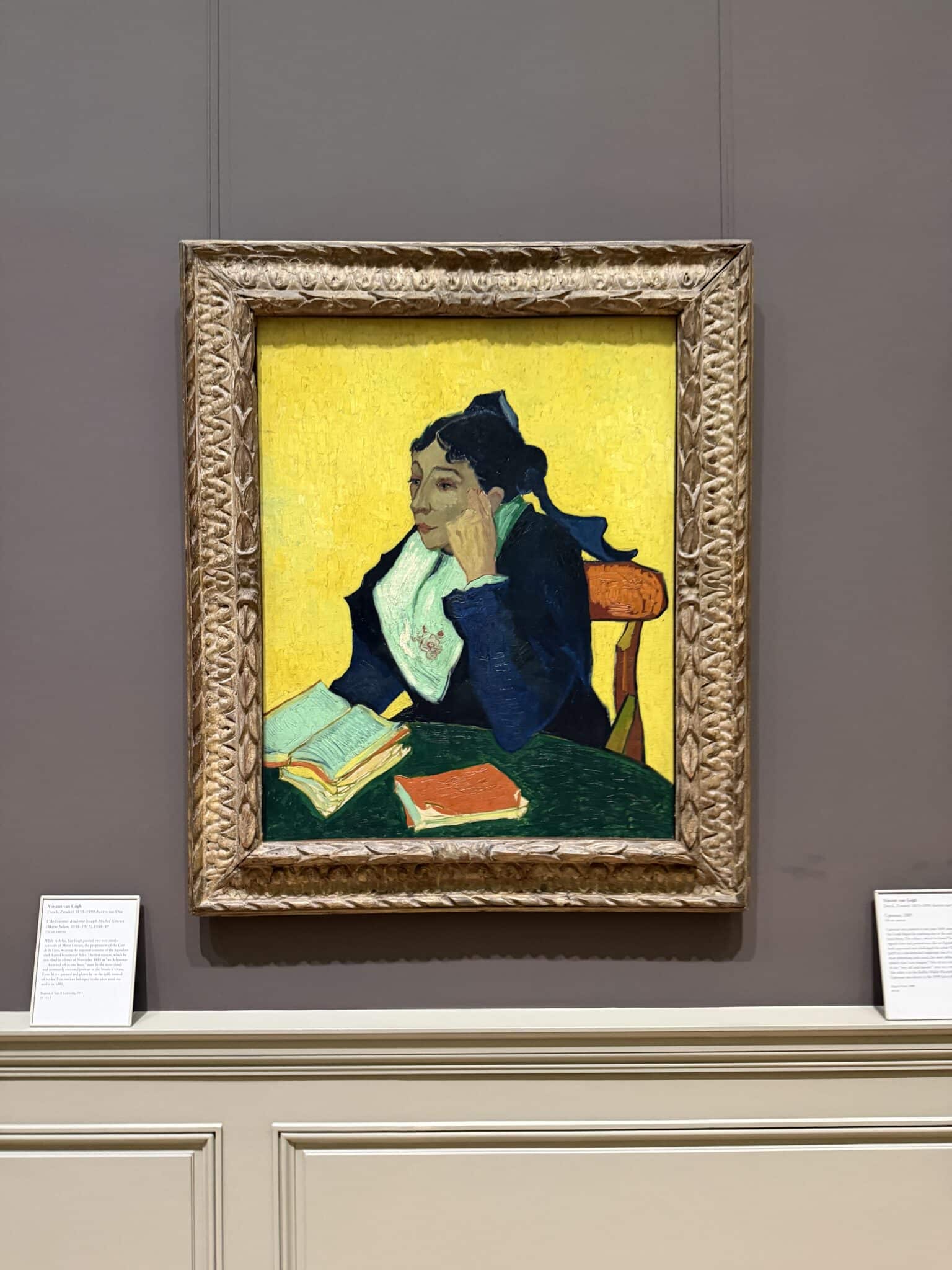 Van Gogh’s L’Arlésienne hangs up against a grey wall