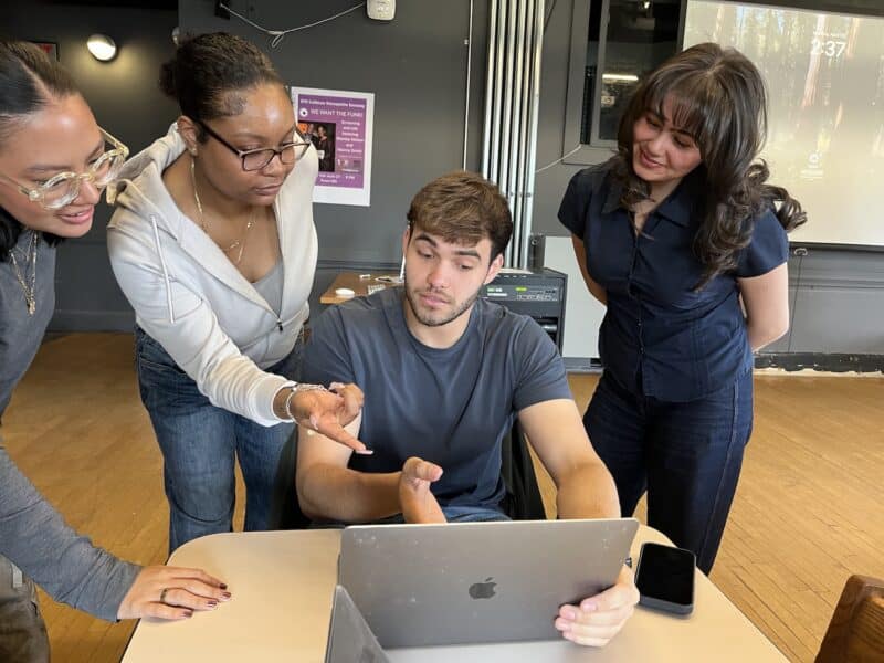Students arounda computer