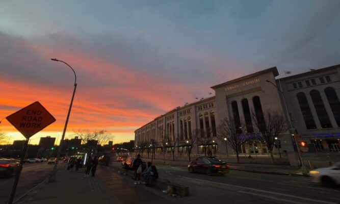 Yankee Stadium at sunset people waiting for a bus. Photo by Katherine Diaz Sanchez