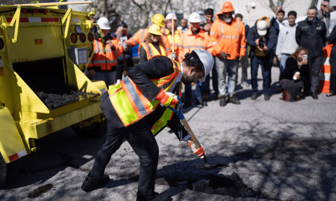 Mayor Zohran Mamdani filling a pothole. Photo by NYC