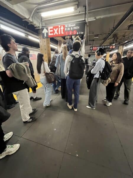 People waiting to go up the subway steps