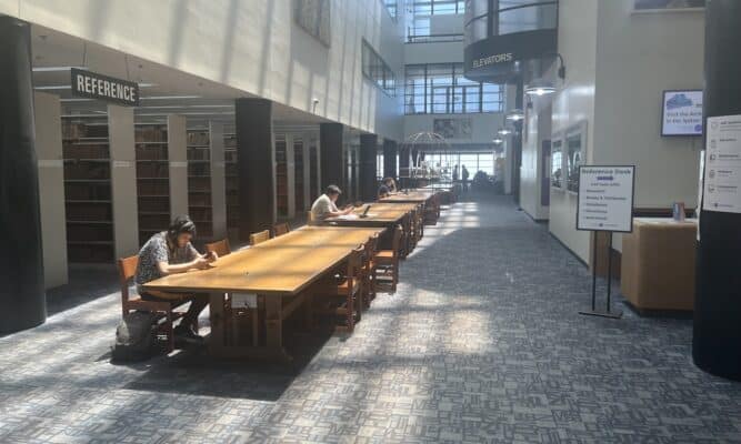 Students on their phones in Cohen Library