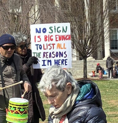 a protest sign reads "no sign is big enough to list all the reasons i'm here."