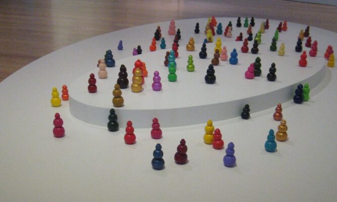 multicolored dog toys arranged on a raised white display.