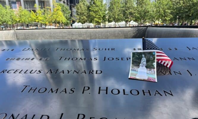 American flag and photo on a name at the 9/11 Memorial pool. Photo by Harlem View.